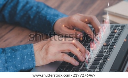 Businessman using laptops show a growing virtual hologram to planning and strategy, Stock market Investments Funds and Digital Assets, business growth, progress, or success. business finance concept. 