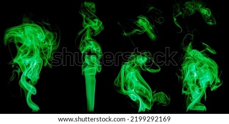 A set of isolated samples of green smoke on a black background. Clouds and bizarre swirls of smoke. Isolate.