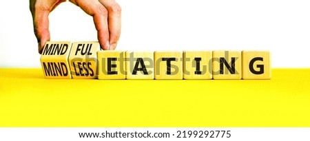 Mindful or mindless eating symbol. Doctor turns cubes and changes words mindless eating to mindful eating. Beautiful white background, copy space. Medical and mindful or mindless eating concept. Royalty-Free Stock Photo #2199292775