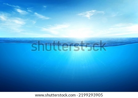 BLUE UNDER WATER waves and bubbles. Beautiful white clouds on blue sky over calm sea with sunlight reflection, Tranquil sea harmony of calm water surface. Sunny sky and calm blue ocean. Royalty-Free Stock Photo #2199293905
