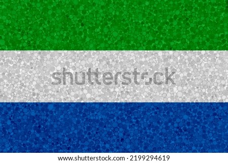 Flag of Sierra Leone on styrofoam texture. national flag painted on the surface of plastic foam
