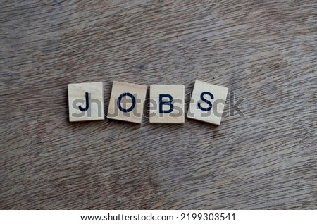Jobs text in wooden square, business quotes