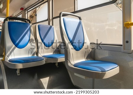 New comfortable seats inside a modern public bus. Seats on the bus for the elderly, people with disabilities and passengers with children. Special seats for certain categories of passengers. Royalty-Free Stock Photo #2199305203