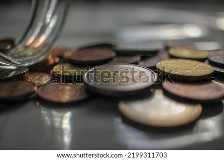 some coins spread out on the table to pay for transport
