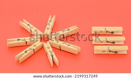 wooden clothespins and paper close-up on a red background Royalty-Free Stock Photo #2199317249