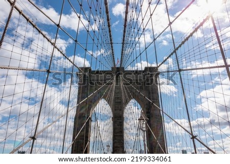 Symmetrical shot of the Brooklyn Bridge with beautiful clouds and blue sky, Brooklyn, USA, EEUU
