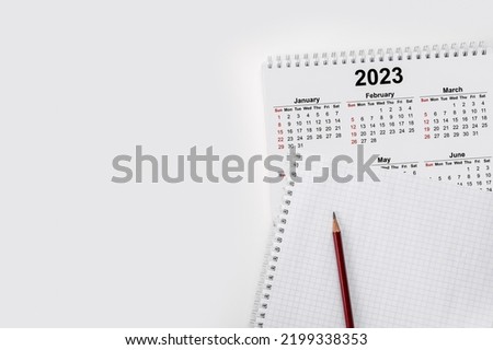 Calendar Year 2023 schedule with blank note for to do list on paper background. Flat lay with calendar, pencil on calander 2023. Close-up of a pencil on the page of a calendar 2022. isolated on white