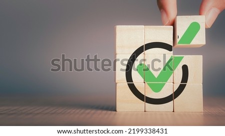 Checklist, Corporate regulatory and compliance, approve, Quality control management, ISO certification, service quality warranty concept. Check mark icon on wooden cube blocks with copy space. Royalty-Free Stock Photo #2199338431