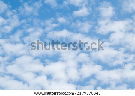 Blue sky with cumulus clouds at daytime. Natural panoramic background photo texture.