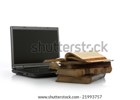 Laptop and old book on white