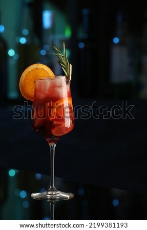 Delicious sangria cocktail on black table in bar