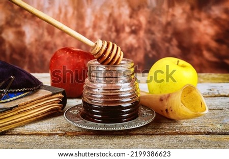 There are many traditional Jewish symbols associated with Rosh Hashanah celebrations, such as apples, honey, pomegranates, and shofars with ritual kosher dessert Royalty-Free Stock Photo #2199386623
