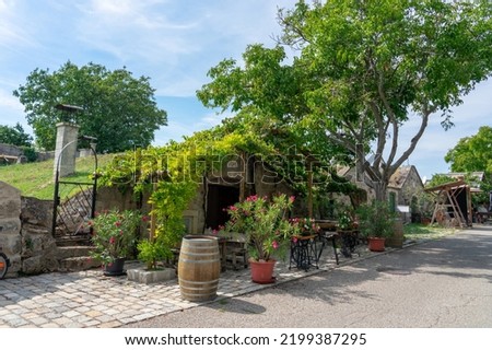 old traditional wine cellar row in Purbach Austria next to Lake Neusiedl . Royalty-Free Stock Photo #2199387295