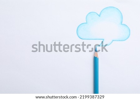 Drawing of cloud and light blue pencil on white background, top view