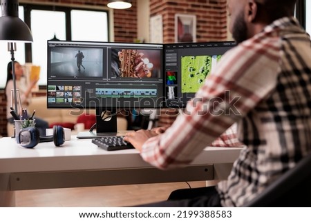 Content creator editing video montage on film production software, working on movie footage to create professional multimedia content. Using creative app with grading on computer. Royalty-Free Stock Photo #2199388583
