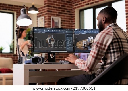 Male developer working with manufacturing software to develop industrial machinery and gears model. Engineering technical machine product on computer, construction industry development. Royalty-Free Stock Photo #2199388611
