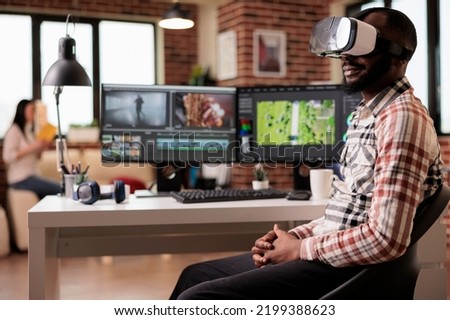 Graphic artist using vr glasses to edit video, working on post production montage with virtual reality headset and creative software on computer. Content creator making film or movie.
