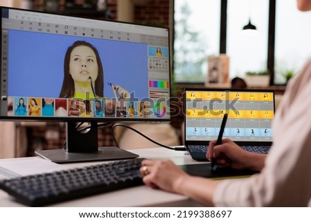 Creative freelancer editing picture with retouching software, using graphic tablet to edit image for multimedia production. Visual content creator using photography retouch interface. Royalty-Free Stock Photo #2199388697