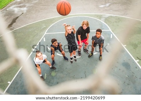 A great child Team in sportswear playing basketball game