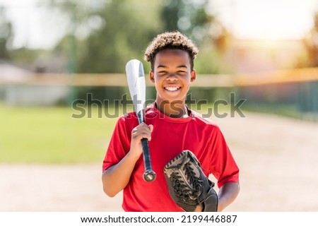 A portrait of child with glove and looking at camera playing baseball Royalty-Free Stock Photo #2199446887
