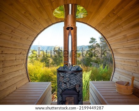 The inside view of the outdoor barrel sauna in the wild. Royalty-Free Stock Photo #2199449287