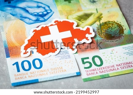 Swiss flag against the background of Swiss francs, currency security concept Royalty-Free Stock Photo #2199452997