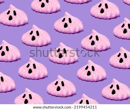 Festive look of a candy ghost pattern on a pastel lilac background. Surreal funny idea, holiday trendy concept for Halloween and Autumn.