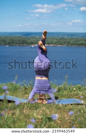 Fitness exercises. Sports woman doing gymnastics in summer park
