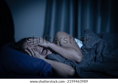 Asian women have a high concern that is why she can't sleep.Have stress from work,Dream of seeing a ghost Royalty-Free Stock Photo #2199463989