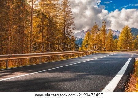 Beautiful landscape with roadway. Highway in mountains in autumn day in Italy, empty asphalt road. Dolomites, Alps  Royalty-Free Stock Photo #2199473457