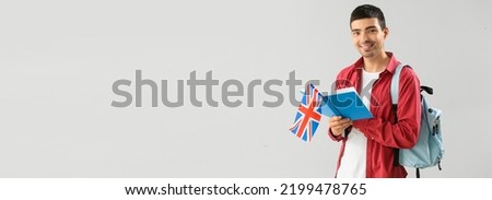 Young male student with UK flag and book on light background with space for text Royalty-Free Stock Photo #2199478765