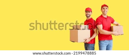 Delivery men holding parcels on yellow background with space for text