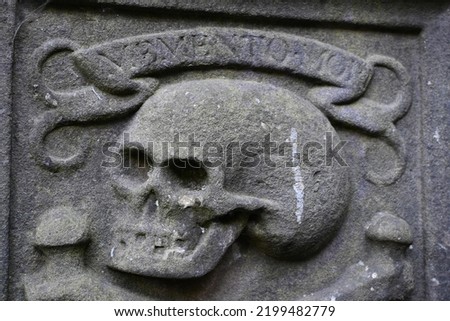 Skull and Memento Mori motto carved into gravestone in Greyfriars Cemetery in centre of Edinburgh, Scotland Royalty-Free Stock Photo #2199482779
