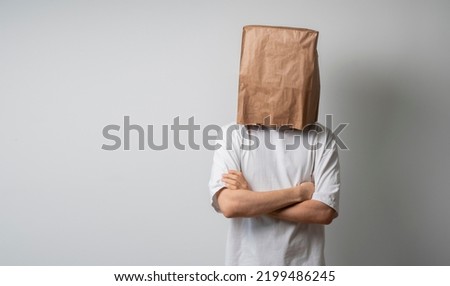 person with blank paper bag on head, mockup template Royalty-Free Stock Photo #2199486245