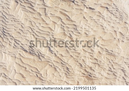 texture of white stones in pamukkale. white layers of calcium in Turkish pamukkale. white mounds of minerals from large amounts of evaporated water.