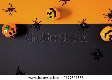 Halloween decorations concept. Halloween with with big spiders and pumpkin on black background. Flat lay, top view, copy space