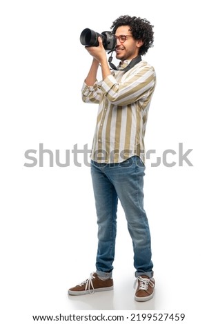 photography, profession and people and concept - happy smiling man or photographer in glasses with digital camera over white background