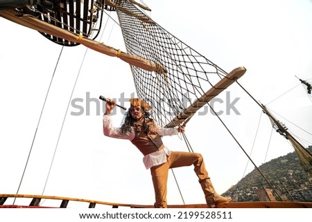 funny the pirate captain traveler  discoverer and explorer on the vintage pirate ship  on white background