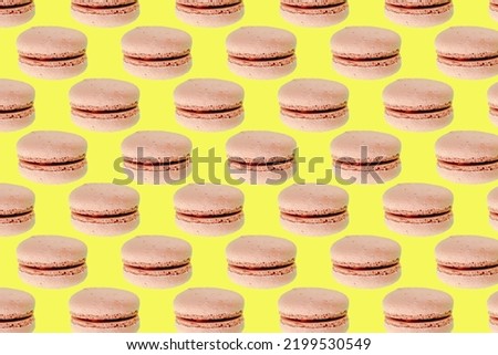 Sweet chocolate macarons,cookies on yellow background seamless pattern. Food dessert flatly flat lay of delicious sweet nibbles, pastry, confectionery, tasty sugar food top view.
