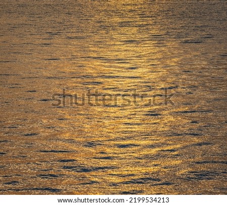 Photo of the surface water in the sunset time. Calm sea with sunset sky and sun through the clouds over. Meditation ocean background. Tranquil seascape. Horizon over the water. Travel photo, nobody