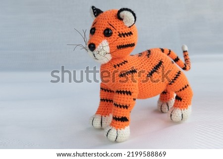 Soft handmade amigurumi doll tiger cub. Symbol of 2022.