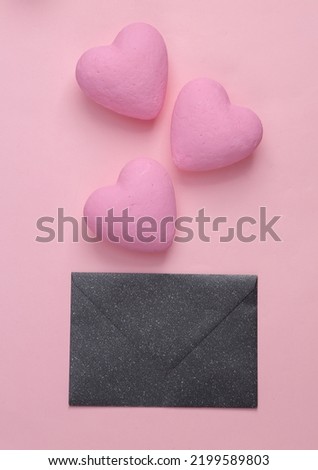 Love letter. Envelope with hearts on a pink background. Top view