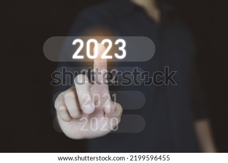 Come to 2023 year concept, People selected on 2023 year icon on visual screen.
