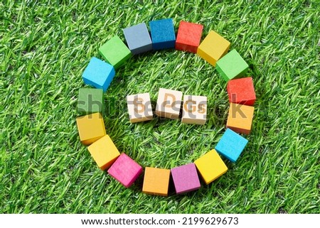SDG symbols and a wooden cube stamped with the letters SDGs. Royalty-Free Stock Photo #2199629673