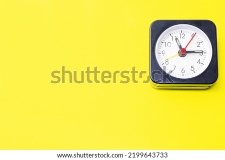 Clock on a yellow background.