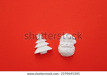 Plaster figure of Christmas tree on a colored background