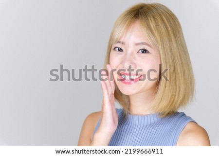 portrait of attractive asian woman with blond hair
