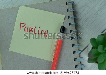 Concept of Publish write on a book isolated on Wooden Table. Selective focus on Publish text