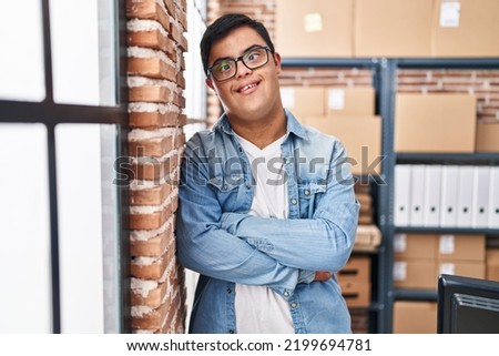 Down syndrome man ecommerce business worker standing with arms crossed gesture at office Royalty-Free Stock Photo #2199694781