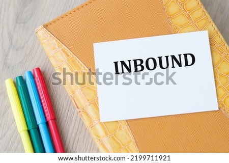 Text inbound on a card lying on a closed yellow notepad. Business concept